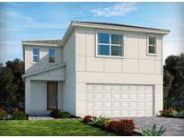 Modern two-story home featuring a two-car garage, clean lines, and lush landscaping at 1127 Cumberland Trail Dr, Lake Hamilton, FL 33851
