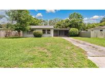 Charming single-story home with a well-maintained lawn and screened in front porch at 1202 Randolph St, Sanford, FL 32771