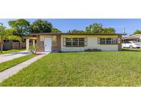 Charming single-story home featuring a well-maintained lawn and classic curb appeal on a sunny day at 2222 Catherine St, Kissimmee, FL 34741