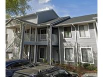 A gray two-story condo building featuring a staircase and balcony at 2236 Stonington Ave # 2236, Orlando, FL 32817