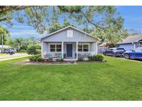 Charming single-story home with a well-manicured lawn and inviting front porch at 2401 Mayer St, Orlando, FL 32806