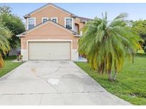 Inviting two-story home featuring a neutral stucco exterior and attached two-car garage at 437 Bridgewater Court, Kissimmee, FL 34758
