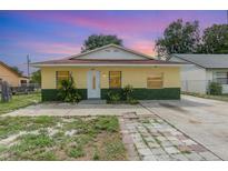 Charming single-story home with a yellow exterior, well-maintained lawn, and inviting entrance at 450 S Buena Vista Ave, Orlando, FL 32835