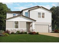 Charming two-story home with gray siding, stone accents, manicured lawn, and an attached two-car garage at 4549 Windy Oak Way, St Cloud, FL 34772
