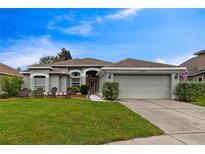 Charming single-story home featuring a well-manicured lawn and attached two-car garage at 1012 Marisol Ct, Orlando, FL 32828