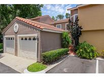 Attached two-car garage with tile roof and well-maintained landscaping at this home at 1013 Inlet Way, Altamonte Springs, FL 32714
