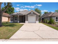 Charming single-story home featuring a well-maintained lawn and a cozy, inviting entrance at 13169 Odyssey Lake Way, Orlando, FL 32826