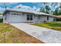 Charming single-story home with a metal roof, one-car garage and newly paved driveway at 160 Chestnut Ave, Orange City, FL 32763