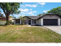 Charming single-story home with a well-maintained lawn and attached two-car garage at 1633 Pinehurst Dr, Casselberry, FL 32707