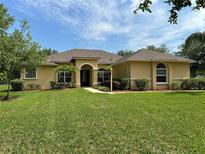 Beautiful single-story home with a well-manicured lawn and a charming front entrance with beautiful landscaping at 19123 Sheldon St, Orlando, FL 32833