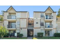 Exterior view of a two-story condo building with balconies and well-maintained landscaping at 1932 Lake Atriums Cir # 69, Orlando, FL 32839