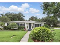 Charming single-story home featuring a well-manicured lawn and beautiful landscaping at 2109 Montana St, Orlando, FL 32803