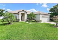 Charming single-story home with well-manicured lawn and lovely landscaping at 236 Boxwood Dr, Davenport, FL 33837