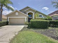Charming single-Gathering home featuring a well-manicured front yard and a two-car garage, ideal for comfortable living at 2641 Hemingway Ave, Haines City, FL 33844