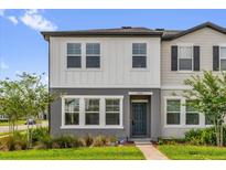 Charming two-story home featuring a well-manicured lawn and modern architectural details at 3206 Water Sprite St, Orlando, FL 32808