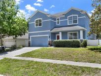 Charming two-story home with a well-manicured lawn and two car garage at 3259 Alling Ct, Deltona, FL 32725