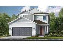 Charming two-story home with a modern design, featuring a gray garage door and a cozy front porch at 5684 Gingham Dr, Kissimmee, FL 34758