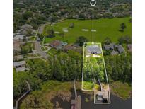 Stunning aerial view of lakeside home with boat dock and golf course access at 5913 Masters Blvd, Orlando, FL 32819