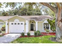 Charming single-story home featuring an attached garage and well-manicured landscaping at 644 Villa Ct, Clermont, FL 34711