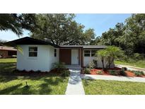 Charming single-story home with lush landscaping and a well-manicured lawn at 1011 W 16Th St, Sanford, FL 32771
