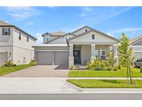 Charming two-story home with a well-manicured lawn and welcoming front porch at 16013 Silver Brook Way Way, Winter Garden, FL 34787