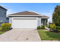 Charming one-story home featuring a two-car garage, well-maintained landscaping, and a welcoming facade at 2130 Bur Oak Blvd, St Cloud, FL 34771