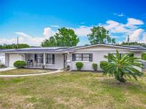 Charming single-story home with a well-manicured front yard and modern solar panels at 2203 Beatrice Dr, Orlando, FL 32810