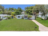 Charming single-story home with a well-maintained lawn and mature trees offering curb appeal at 2525 Lafayette Ave, Winter Park, FL 32789