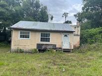 Modest exterior view of small home with two windows and mature landscaping at 31520 Colby Pl, Sorrento, FL 32776