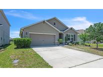 Charming single-story home with a well-maintained lawn, two car garage and a neatly landscaped garden at 5234 Bear Corn Run, Port Orange, FL 32128