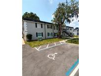 Two-story apartment building with black shutters and a handicap parking spot at 7636 Forest City Rd # 072A/K/A H, Orlando, FL 32810