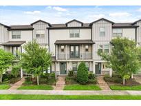 Charming townhouse with well-kept landscaping, gray trim, covered entry, and quaint balcony at 7724 Sweet Star Ave, Orlando, FL 32836