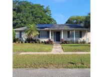 Charming single-story home with well-maintained lawn, garden, and solar panels at 8539 Clematis Ln, Orlando, FL 32819