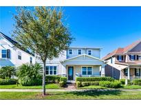 Charming two-story home with a well-manicured lawn, beautiful landscaping, and inviting curb appeal on a sunny day at 14753 Snowy Egret St, Winter Garden, FL 34787