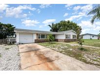 Charming single-story home featuring a one car garage and long driveway at 1962 English Dr, Deltona, FL 32738