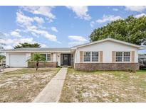Charming one-story home with a well-maintained lawn and inviting front entrance at 1962 English Dr, Deltona, FL 32738
