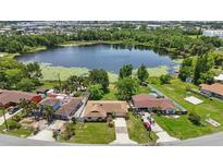 Aerial view of a charming neighborhood with lake access and lush greenery at 2028 Lake Christie Dr, Orlando, FL 32809