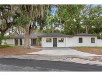 Charming one-story home featuring a freshly painted exterior and mature trees at 22 Hillcrest Dr, Babson Park, FL 33827