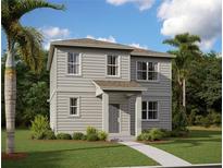 Charming two-story home with gray siding, lush landscaping, and a welcoming front porch at 2365 Zuni Road, St Cloud, FL 34771