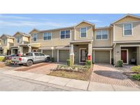 Inviting townhome featuring a private garage and charming front landscaping, showcasing a comfortable and appealing exterior at 3813 Black Spruce Ln, Winter Springs, FL 32708