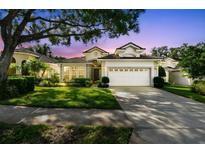 Charming single-story home featuring a well-manicured lawn, mature trees, and a two-car garage at 404 Sotheby Way, Debary, FL 32713