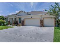 Charming single-story home featuring a two-car garage, stone accents, and well-maintained landscaping at 410 E Victoria Trails Blvd, Deland, FL 32724