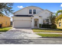 Charming two-story home with a brick driveway and attached two-car garage in a well-maintained community at 558 Cadiz Loop, Davenport, FL 33837