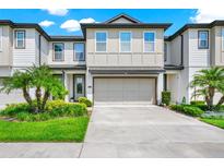Charming two-story townhouse with attached two-car garage and well-manicured landscaping at 652 Benoi Dr, Davenport, FL 33896
