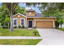 Charming single-Gathering home with a well-manicured lawn, beautiful trees, and a welcoming front door at 805 Gordonia Ct, Deland, FL 32724
