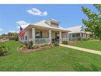 Charming single-Gathering home with a cozy front porch, well-maintained lawn, and the American flag proudly displayed at 106 Turtle Run, Umatilla, FL 32784