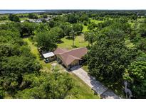 A peaceful property with a single-Gathering home surrounded by lush trees and green space at 1391 Terry Ln, Kissimmee, FL 34744