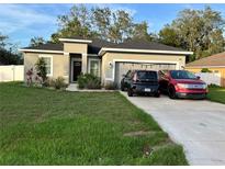 Charming single-story home featuring a well-manicured lawn and a two-car garage at 1884 Snapper Dr, Kissimmee, FL 34759