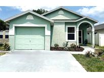 Charming single-story home featuring a well-manicured lawn, a one car garage, and a covered front entrance at 2903 Willow Oak Ct, Kissimmee, FL 34744