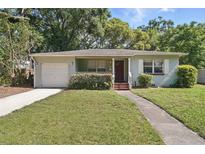 Charming single-story home with a well-maintained lawn and attached garage at 2915 Hargill Dr, Orlando, FL 32806